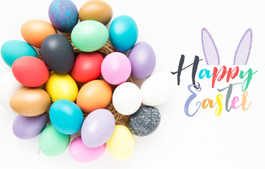 Fototapeta na wymiar Multi-colored Easter eggs in nest on wooden background, selective focus image. Happy Easter card 