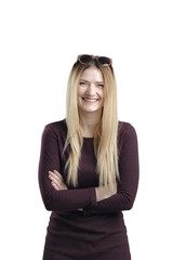 Portrait of young smiling female standing with folded hands over white background