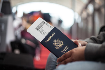 Close Up of American Passport in Airport, Woman Traveling, Hands Holding American Passport in...