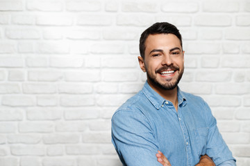 Facial Expressions Of Young Beard Man On Brick Wall