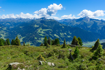 Summer mountain landscape with blue cloudy sky and hang glider. Austria, Tyrol, Zillertal Valley, Zillertal High Alpine Road.