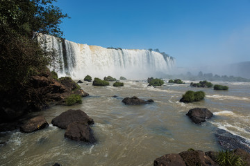 Obraz premium Iguacu Falls, Brazil, the largest in the world in volume of water, ideal for adventure tourism, one of the natural wonders of the world