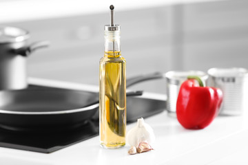 Glass bottle of cooking oil on kitchen counter