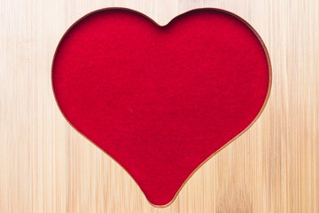 Heart shaped wood on red background