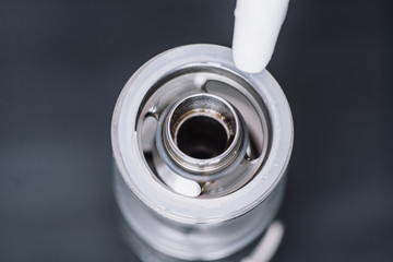 Macro shot of fueling a vape smoking an electronic cigarette, runs vape juice electronic cigarette....