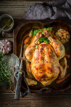 Tasty roasted chicken with hebrs and vegetables