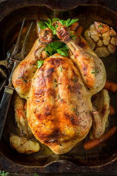 Golden roasted chicken with thyme and carrots