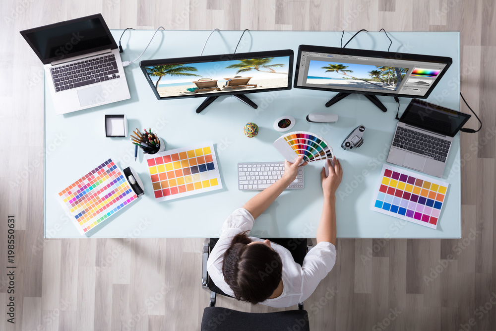 Poster Designer Using Color Swatch While Working On Multiple Computer