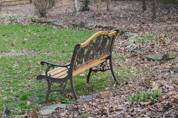 With spring just beginning to spring up, this park bench sits empty.