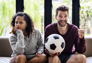 Couple watching a football game