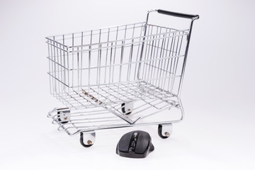 Computer mouse and shopping cart. Online shopping concept