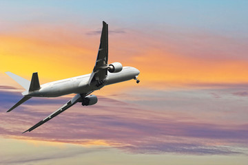 Fototapeta na wymiar Commercial airplane flying above beautiful sky in dramatic sunlight.Travel and transportation concept.