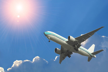 Fototapeta na wymiar Commercial airplane flying above beautiful sky in dramatic sunlight.Travel and transportation concept.