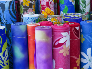 Rolls of brightly patterned Hawaiin fabrics