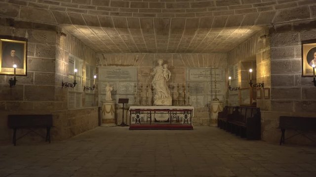 A tomb and statue in a crypt