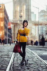 Beautiful happy young fashionable woman traveling in New York City with backpack. Tourists...