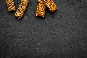 Sport bars for fast energy. Black background top view copy space