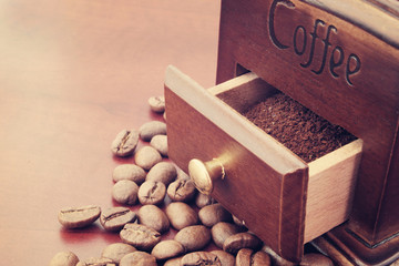 Manual coffee grinder with roasted coffee beans