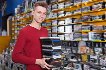 Nice man choosing movies on DVD at store