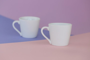 Obraz na płótnie Canvas tableware mockup. Minimalist cup Mockup. white cups on a trendy graphic background in pastel colors.white cup on trend lilac pink graphic background. copy space
