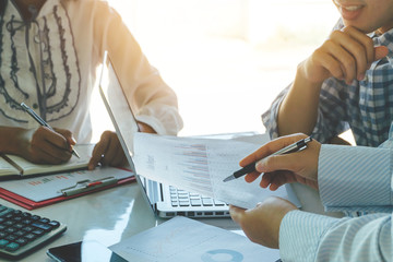 Business team analyzing income charts and graphs with modern laptop computer. Close up.Business analysis and strategy concept.