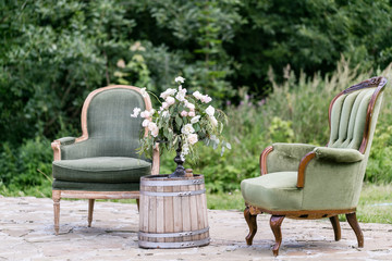 Vintage wood chairs and table with flower decoration in garden. outdoor