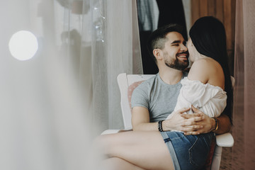 Woman staying in her man's hands and smilling to each other.