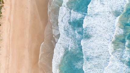 Aerial View of Waves at Beach at Sunset