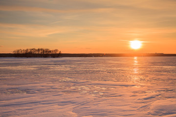 Sunset on the frozen lake