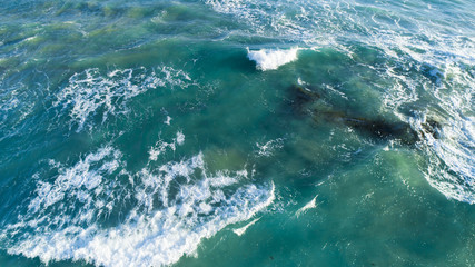 Aerial View of Waves at Beach at Sunset