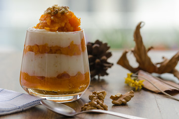 Layered pumpkin dessert with cream and walnut