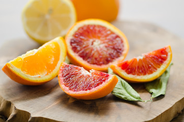 Naklejka na ściany i meble Sliced oranges on the wooden table. Citrus sinensis orange