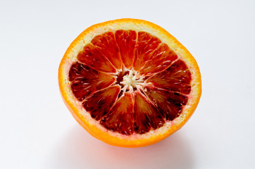 Half orange Citrus sinensis  'Blood orange' on white ground