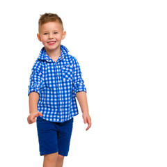 A cute little boy in a shirt and shorts.