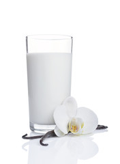 Obraz na płótnie Canvas Vanilla sticks with a flower and glass of milk as ingredient for baking