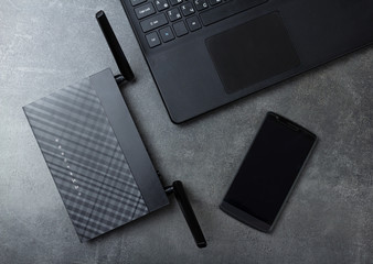 Modern technology-wireless LAN-Wi-Fi, computer and phone on gray