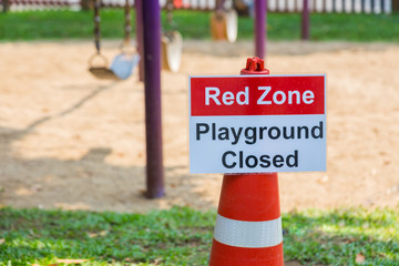 Fototapeta na wymiar Red Zone Playground Closed sign posting at a children playground
