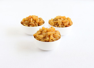 Raisins or dry grapes, organic type, healthy vegetarian food, in a bowl.