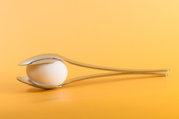 egg white subject with spoon on yellow background and text field