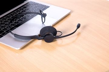 Laptop computer with headset on keyboard