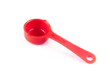 Measuring spoon or cup over the white background.