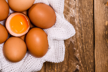 basket with eggs and one broken with egg yolk, with space for text
