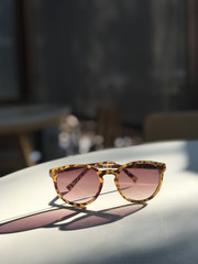 Sunglasses on table in blurred background