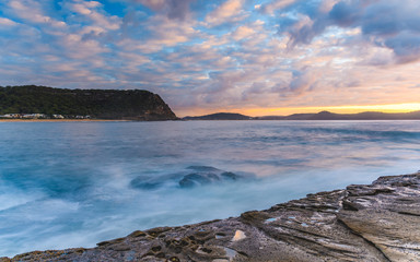 Fototapeta na wymiar Sunrise Seascape with Cloud and Rock Ledge