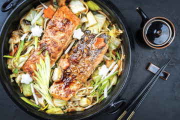 Japanese chan chan yaki hot pot with salmon fillet as top view in traditional cast iron pot