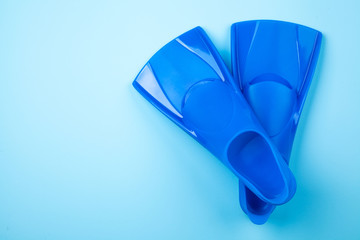 Blue flippers on color background