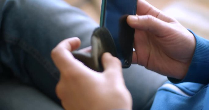 A man pulls out his old phone from the cover