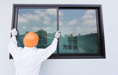 The technician's hands will install aluminum windows.