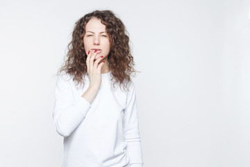 American brunette female with curly hair looks suspiciously into camera, suspects husband in...