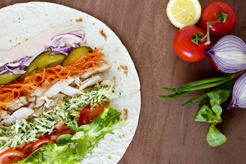 Homemade Shawarma with Chicken Meat fillet and Fresh Vegetables over Wooden Board. cooking Process.